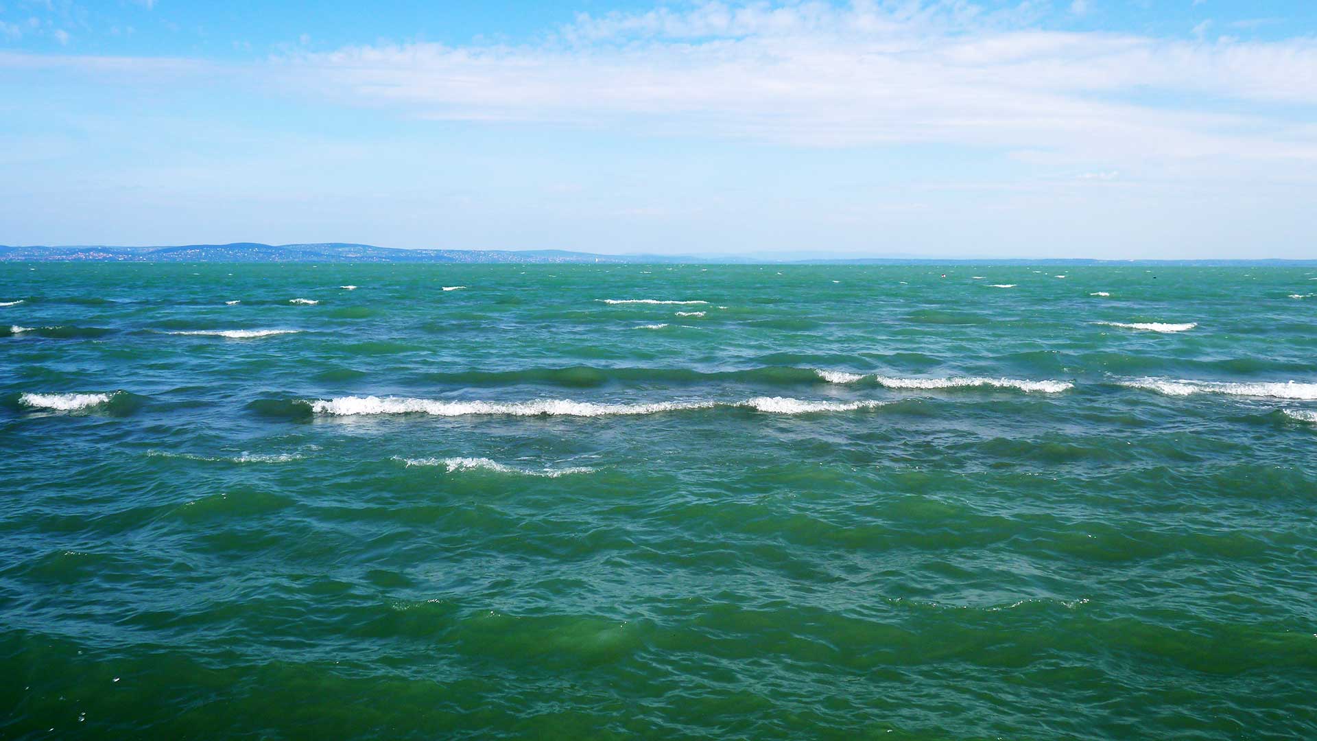 Balaton, bukóhullámok. Ha hirtelen támad fel a szél, még nem keveredett fel a víz, akkor lehet ilyet fotózni. Kék víz, fehér hullámok.
